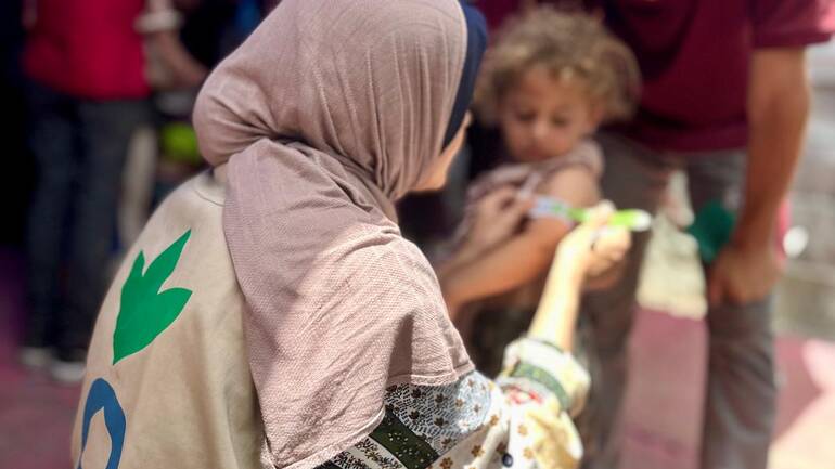 Eine Mitarbeiterin von Aktion gegen den Hunger misst den Oberarmumfang eines Kindes in Gaza im Mai 2025